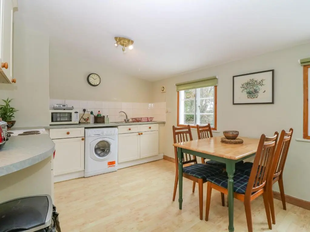 a kitchen with a table and chairs in a kitchen at The Bungalow in Elgin