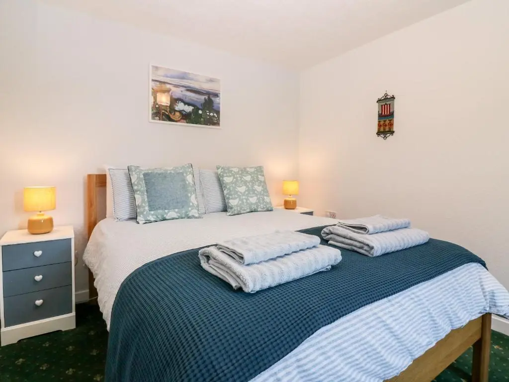 a bedroom with a bed with towels on it at 4 Gordon Street in Buckie
