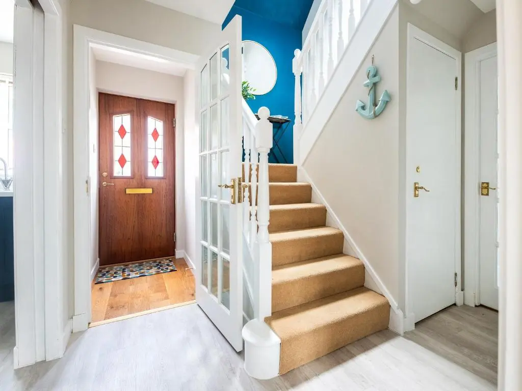 a staircase in a home with blue walls at By The Sea in Avoch