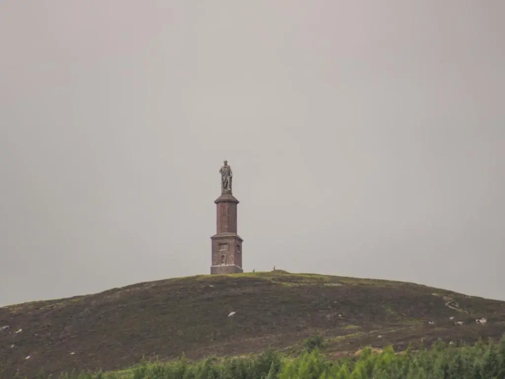 a lighthouse on top of a grassy hill at The Steading in Rogart