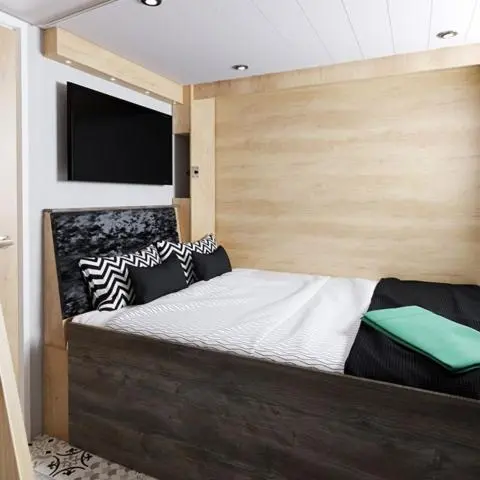 a bedroom with a bed with a wooden head board at The Willy Gunn Pod - Beautiful, luxury pod in Aberlour