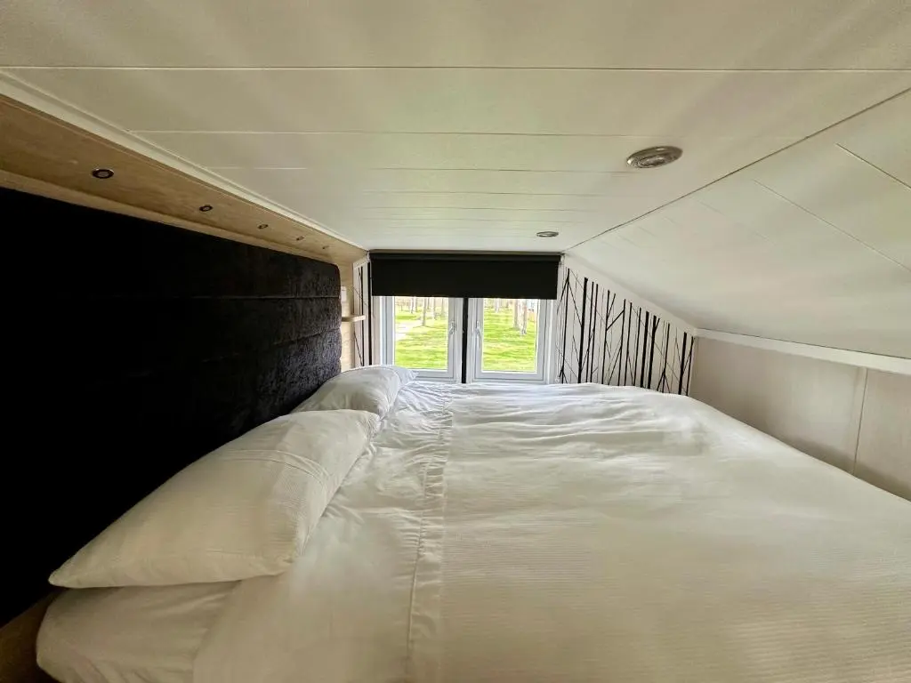 a large white bed in the middle of a room at The Smolt Pod - Beautiful, luxury pod in Aberlour