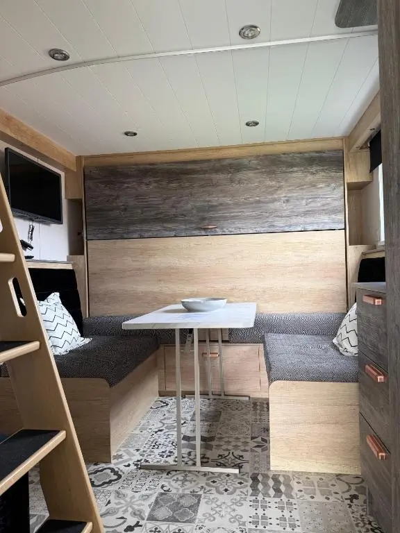 a small room with a table and a couch at The Smolt Pod - Beautiful, luxury pod in Aberlour