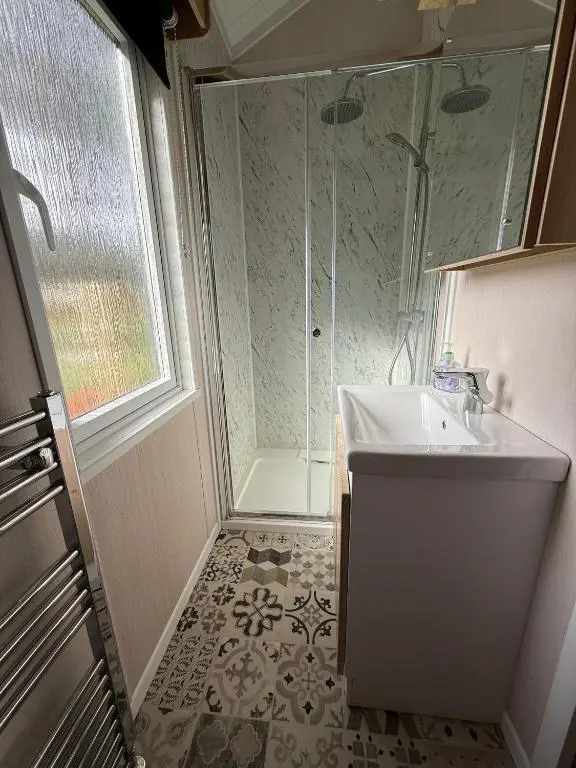 a bathroom with a sink and a shower at The Smolt Pod - Beautiful, luxury pod in Aberlour