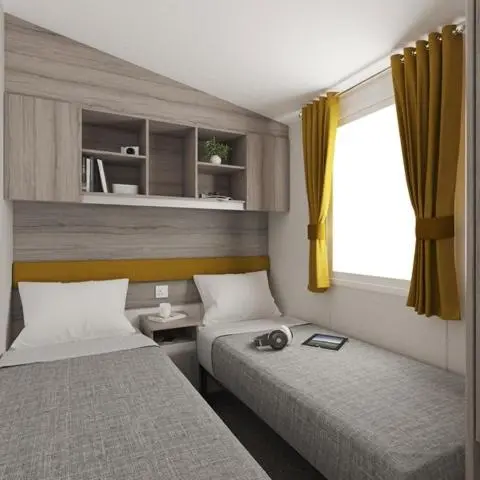 a room with two beds and a window at The Trout Van - Beautiful, luxury static caravan in Aberlour