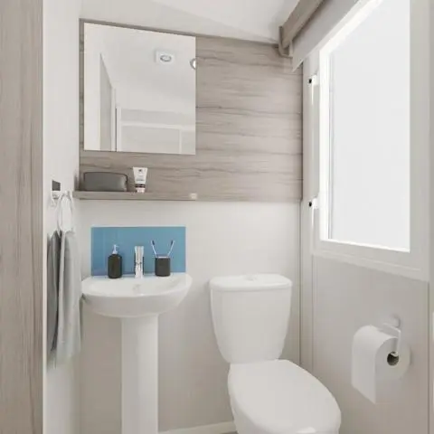 a white bathroom with a toilet and a sink at The Trout Van - Beautiful, luxury static caravan in Aberlour