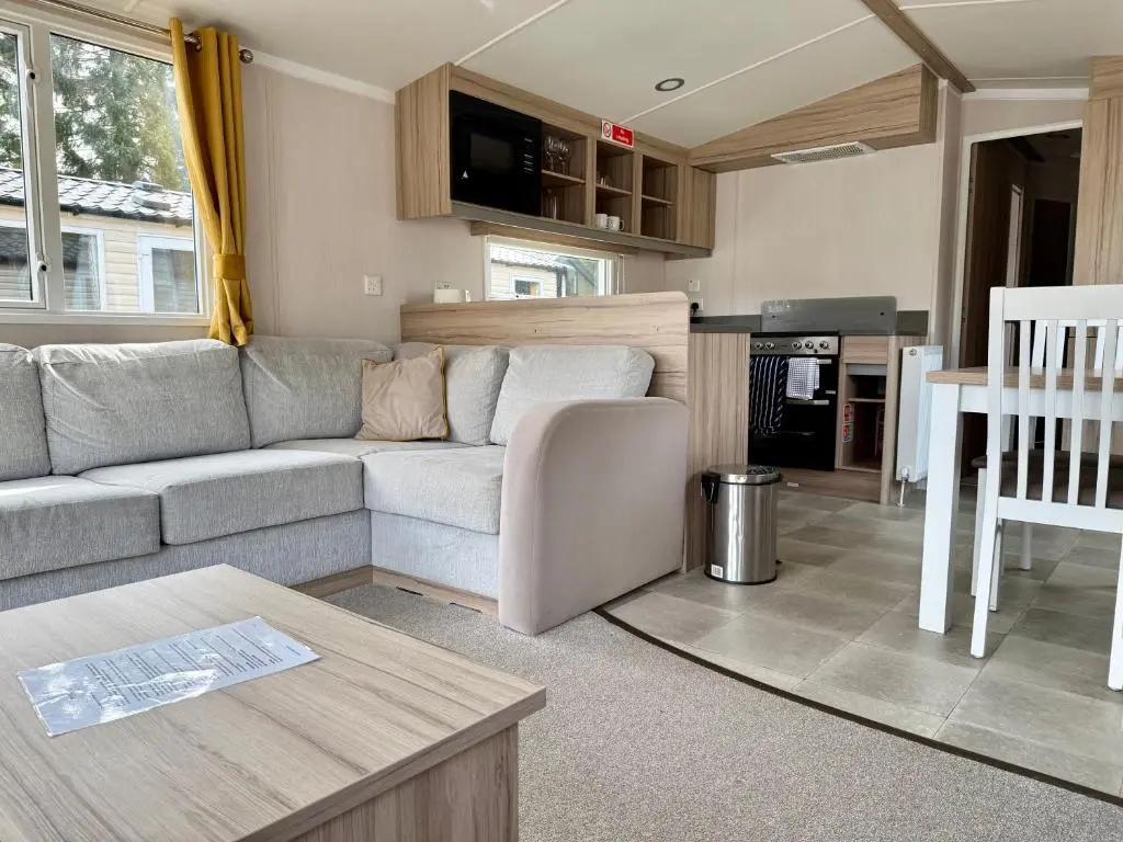 a living room with a couch and a table at The Fly Van - Beautiful, luxury static caravan in Aberlour