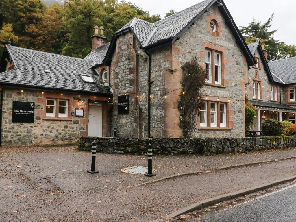an old stone building on the side of a street at 4 River Court in Invergarry