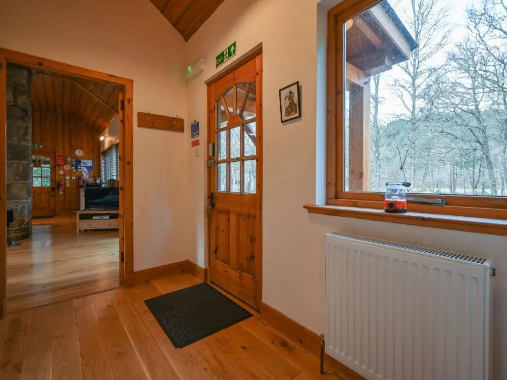 a room with a door and a window and a radiator at Holiday Home Riverside Cottage by Interhome in Inverness