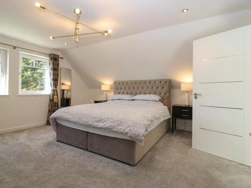 a bedroom with a large bed and a window at Bullpens in Banff