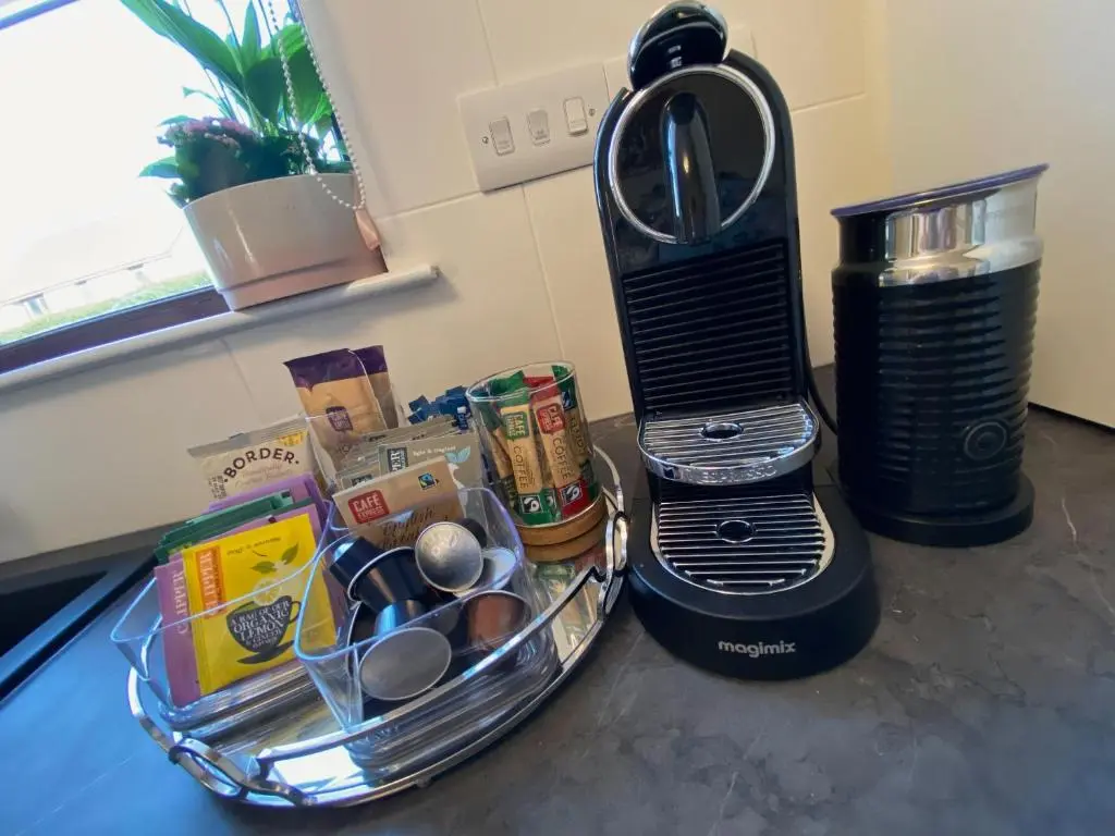 a kitchen counter with a blender and a basket of food at discoverNESS Apartment in Inverness