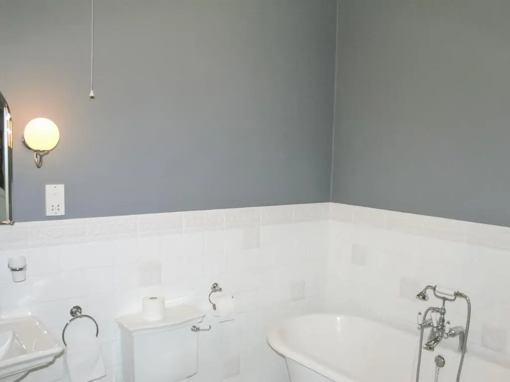 a bathroom with a tub and a toilet and a sink at Treetops in Newtonmore