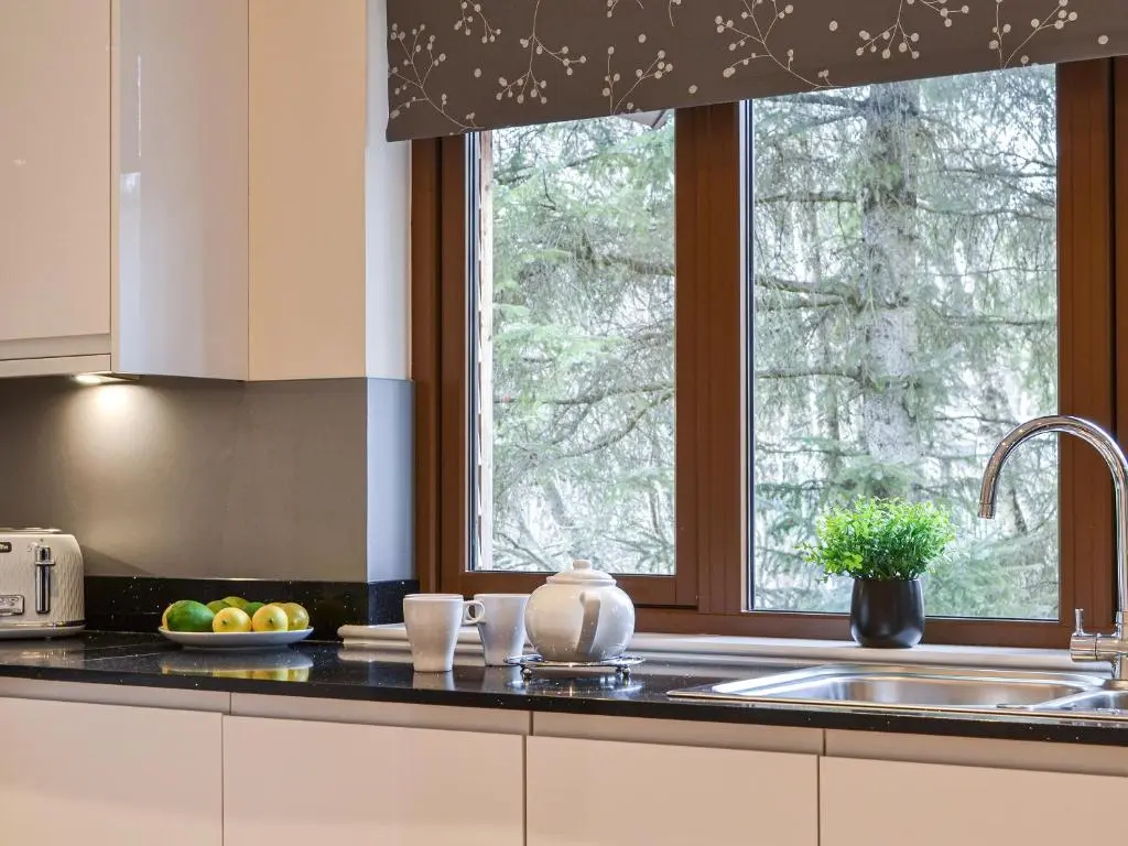 a kitchen counter with a sink and a window at Golf View in Aboyne