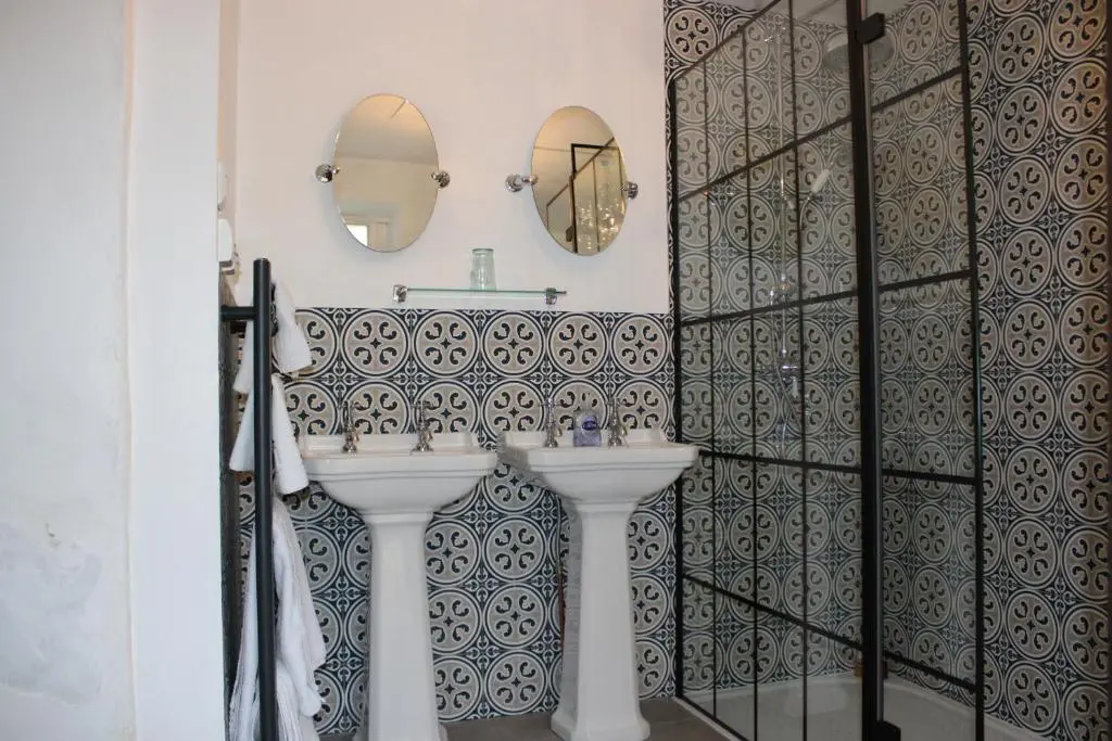 a bathroom with a white sink and a mirror at East Wing Lickleyhead Castle in Auchleven