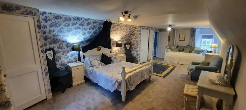 a bedroom with a bed and a living room at West Wing Lickleyhead Castle in Auchleven
