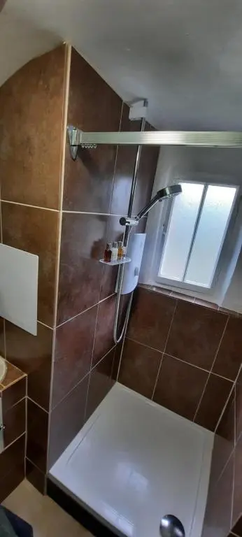 a bathroom with a shower with a window at West Wing Lickleyhead Castle in Auchleven