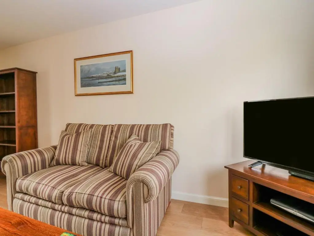 a living room with a couch and a flat screen tv at 10 Goodhope Gardens in Aberdeen