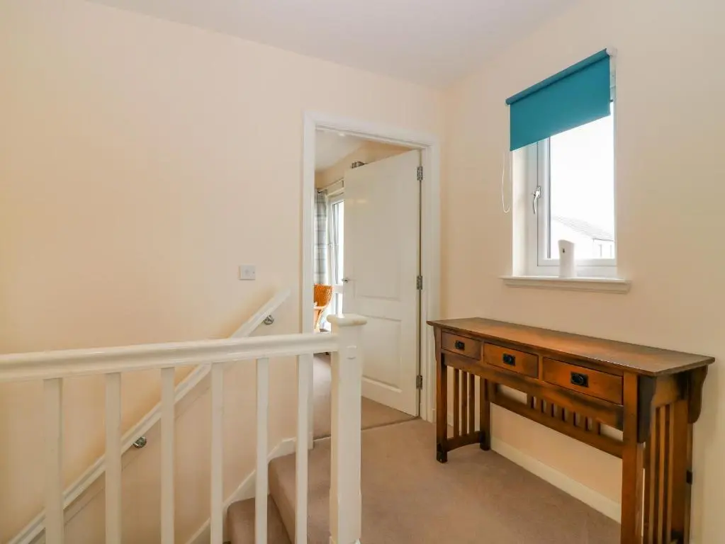 a hallway with a desk and a window at 10 Goodhope Gardens in Aberdeen