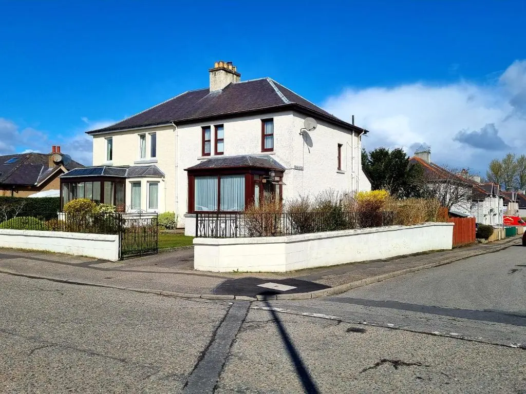 a white house on the side of a street at Inverness City 3 bedroom house free parking in Inverness