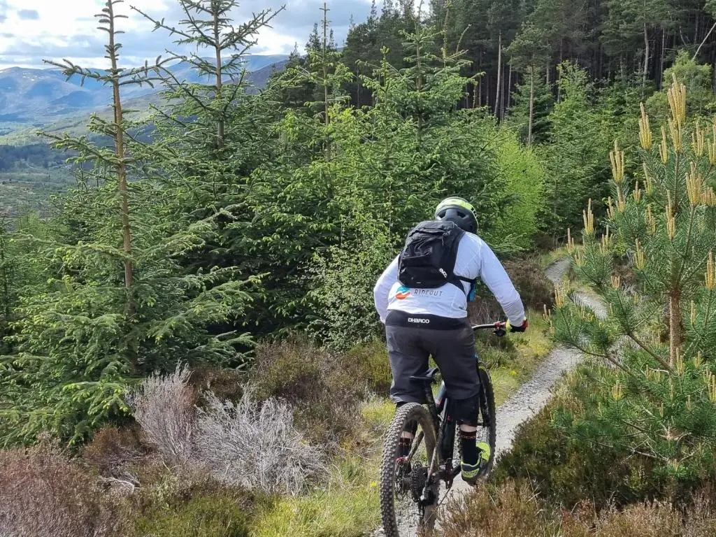 a man riding a bike on a trail at Rose Cottage City Centre in Inverness