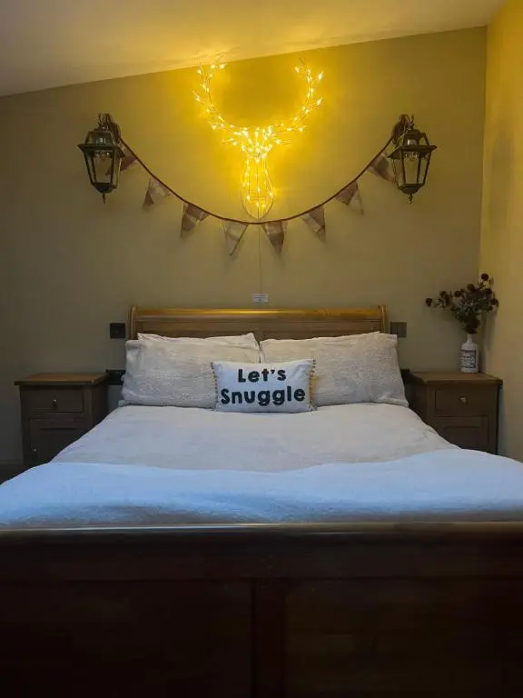 a bedroom with a bed with a sign on the wall at The Stable - NC500 in Wick