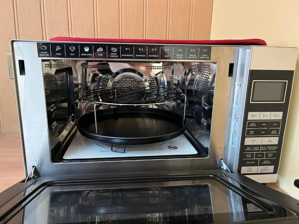 a microwave with a dish inside of it at The Stable - NC500 in Wick