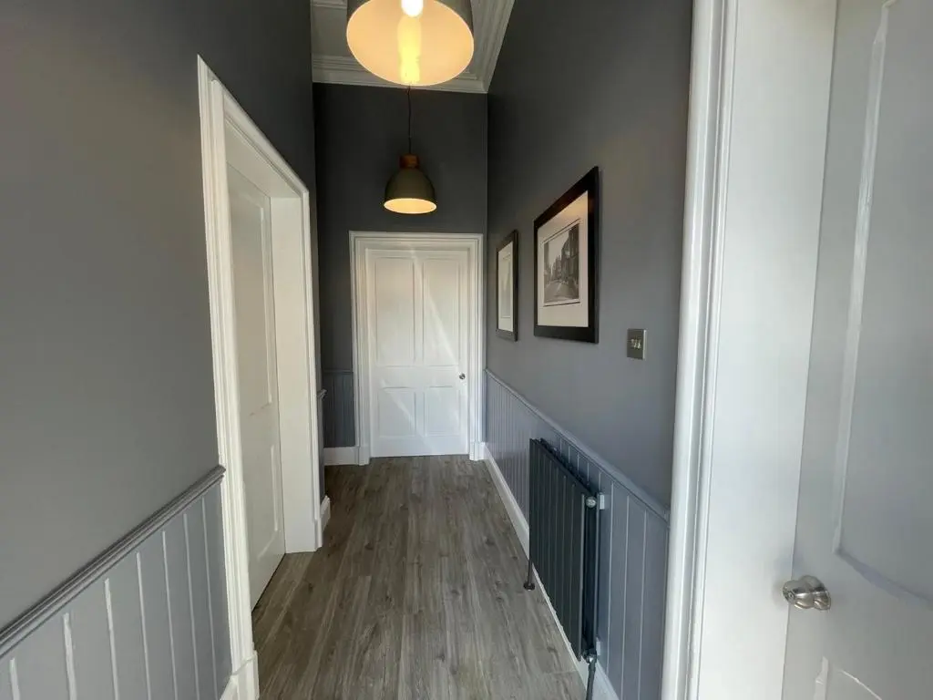 a hallway with gray walls and a white door at The Store by Caithness Luxury Apartments NC500 - Luxury modern conversion with open plan living - Sleeps 4 in Wick