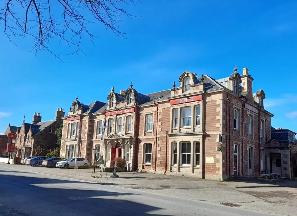a large brick building on the side of a street at Beauly Holiday Home in Beauly