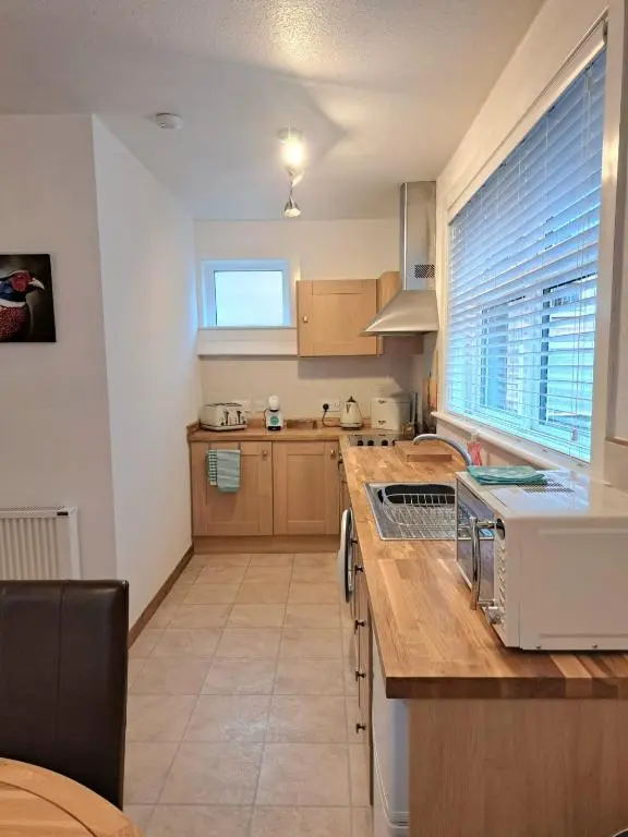 a kitchen with a counter top with a microwave at Old Tavern House in Fortrose