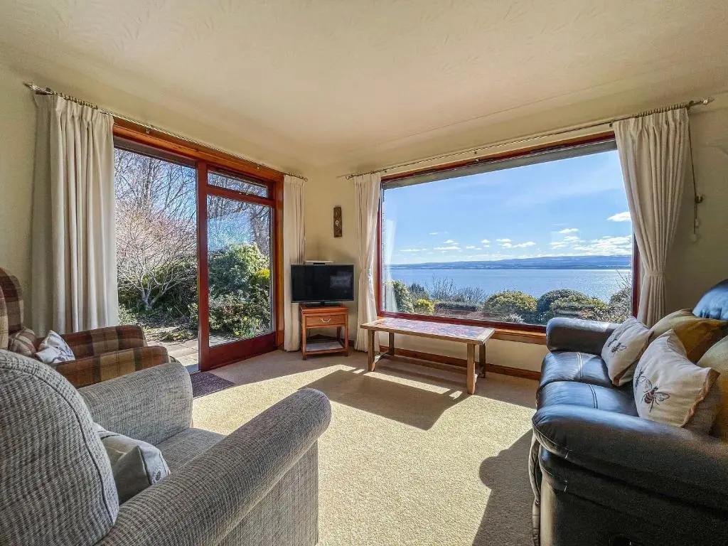 a living room with two couches and a large window at Chanonry View Holiday Cottage in Fortrose