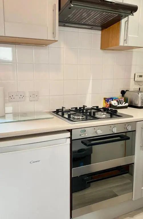 a kitchen with a stove top oven in a kitchen at The Smiddy in Inverness