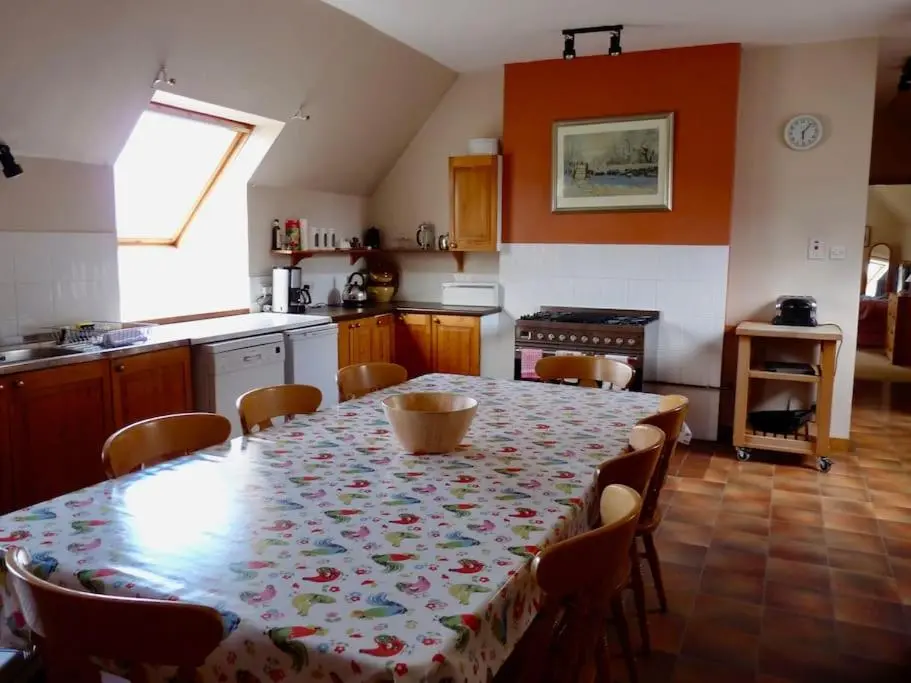 a kitchen with a table and chairs and a kitchen with a tableablish at Tornacraig 8 Person Country House on Royal Deeside in Aboyne