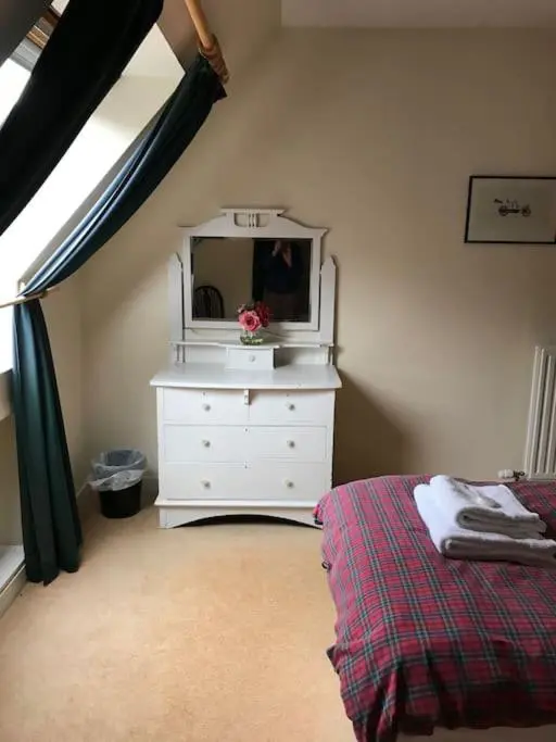 a bedroom with a white dresser and a mirror at Tornacraig 8 Person Country House on Royal Deeside in Aboyne
