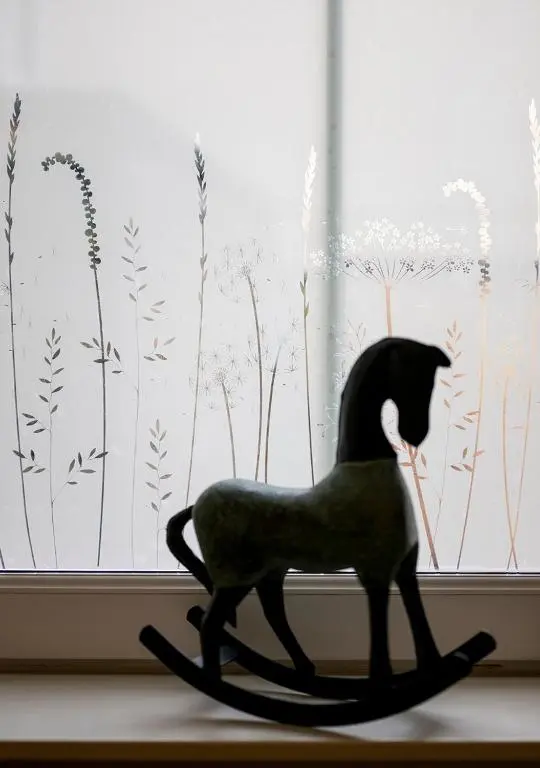 a black cat statue sitting in front of a window at The Hideaway in Inverness