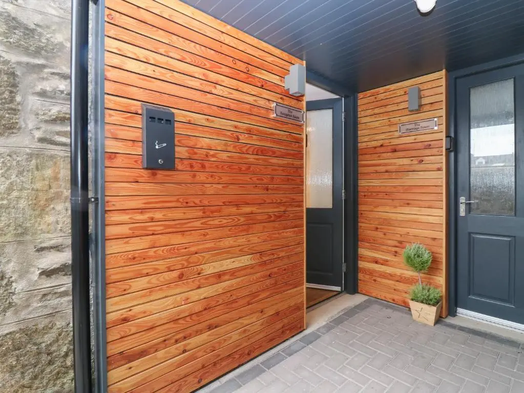 a wooden front door of a house at The Reception Room at The Institute Executive Apartments in Keith