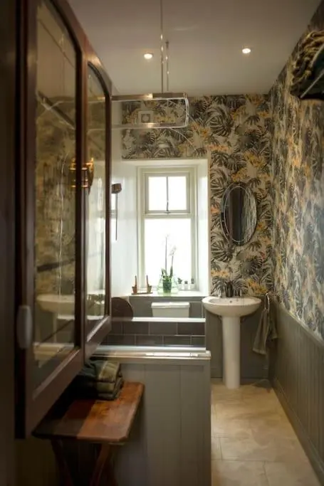 a bathroom with a sink and a toilet and a window at The Presbytery, Forres in Forres