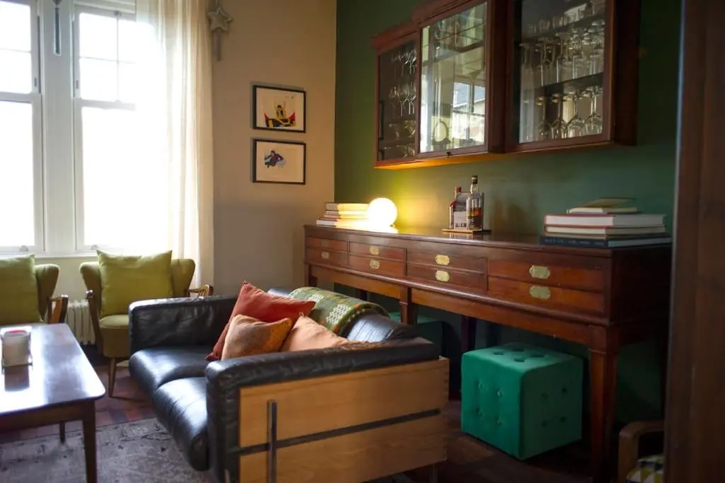 a living room with a couch and a wooden table at The Presbytery, Forres in Forres