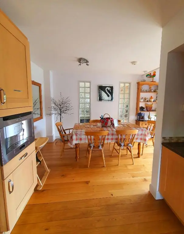 a kitchen and dining room with a table and chairs at Lindas Retreats Self catering accommodation 1 bedroom cottage or 3 bedroom House in Tomintoul
