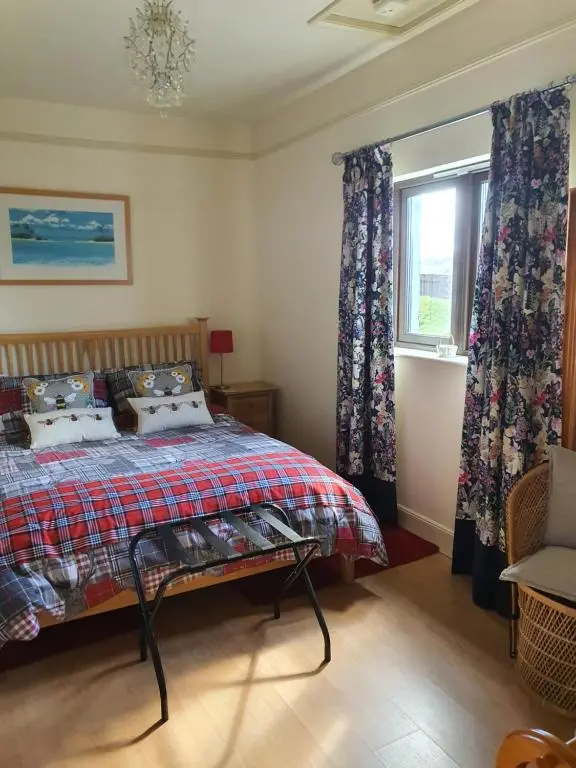 a bedroom with a bed and a window at Lindas Retreats Self catering accommodation 1 bedroom cottage or 3 bedroom House in Tomintoul
