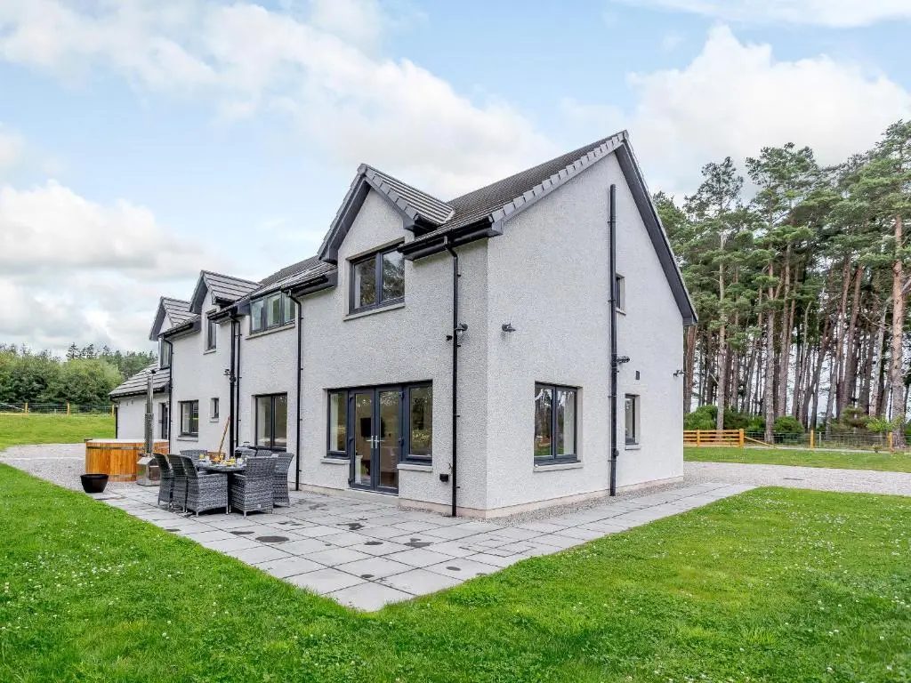 a large white house with a courtyard at Strathclaggan in Aberlour