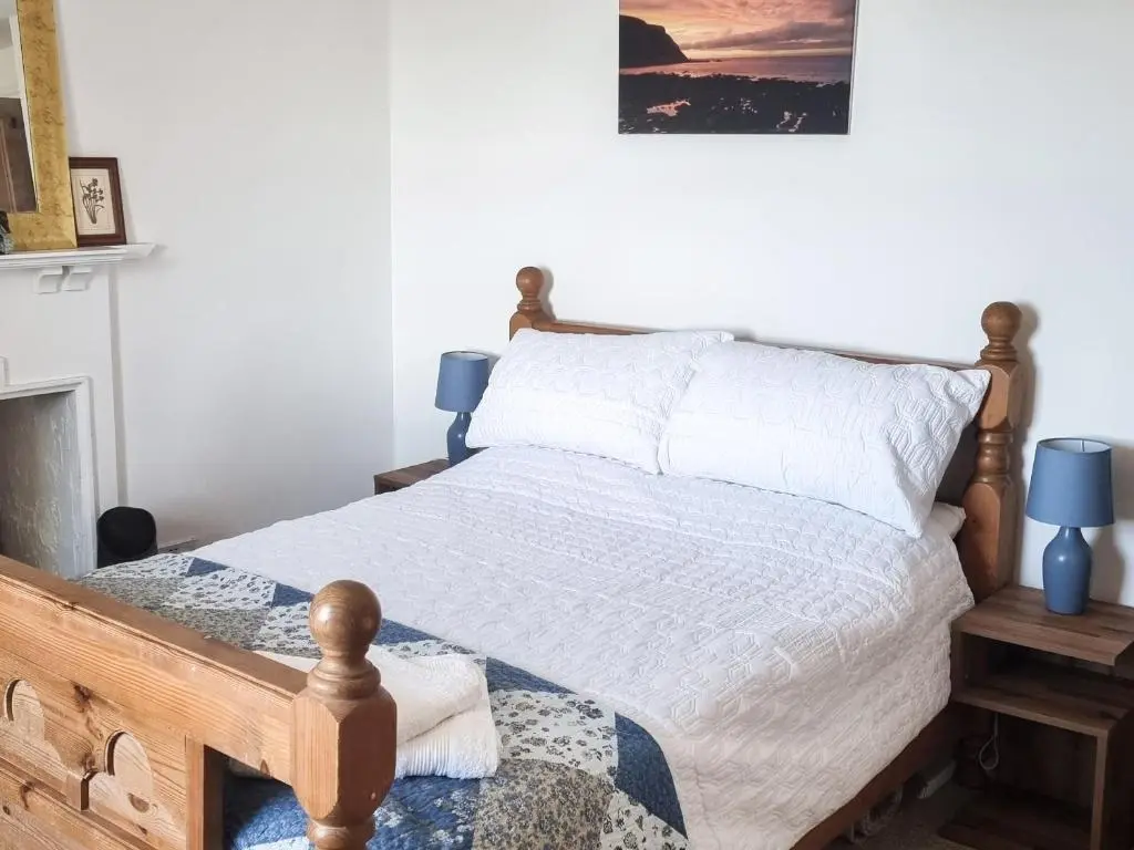 a bedroom with a bed and a fireplace at The Windowky in Gardenstown