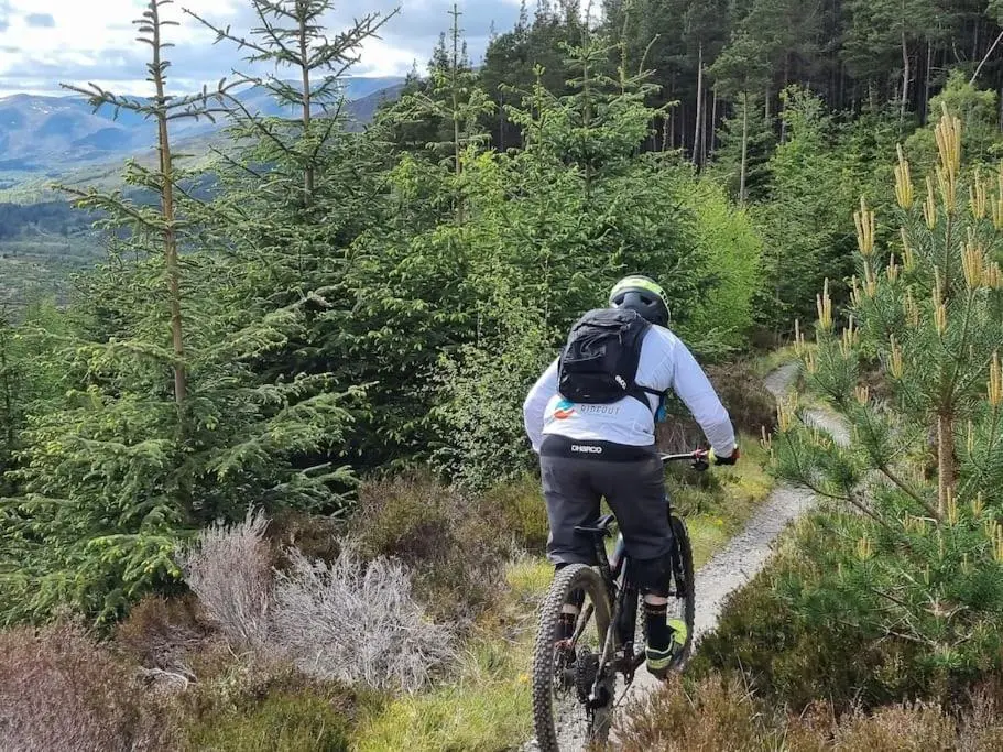 a person riding a bike on a trail at Clava Cottage City Centre in Inverness