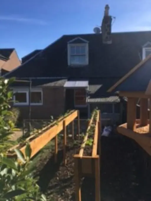a house with a wooden deck in front of it at Clava Cottage City Centre in Inverness