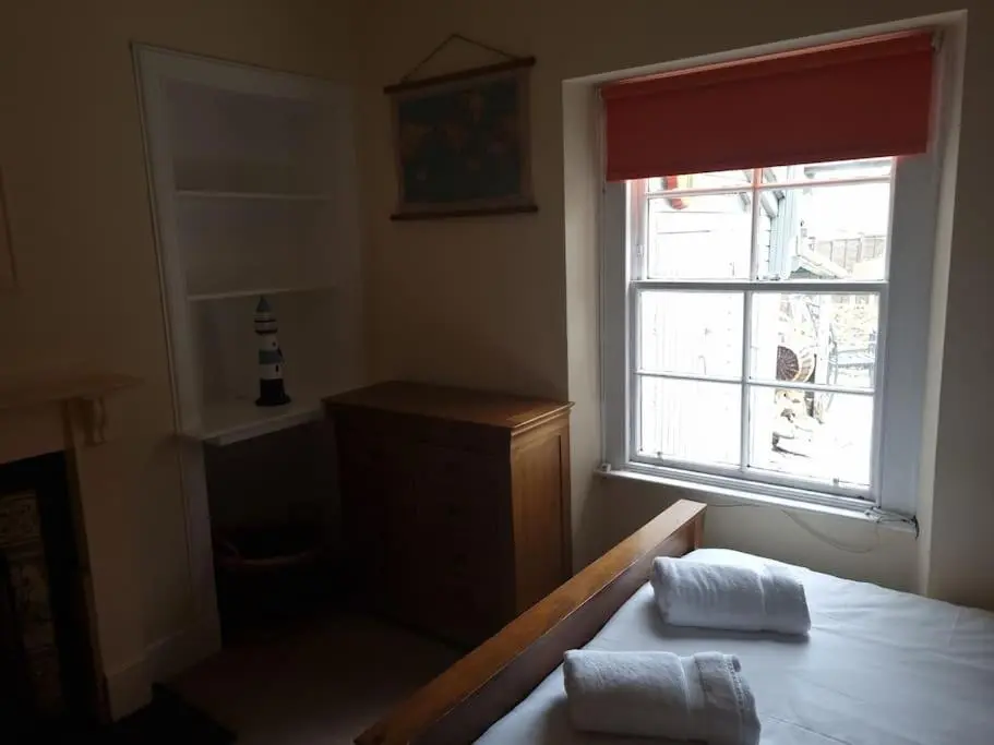 a room with a window and a table with two towels at Clava Cottage City Centre in Inverness