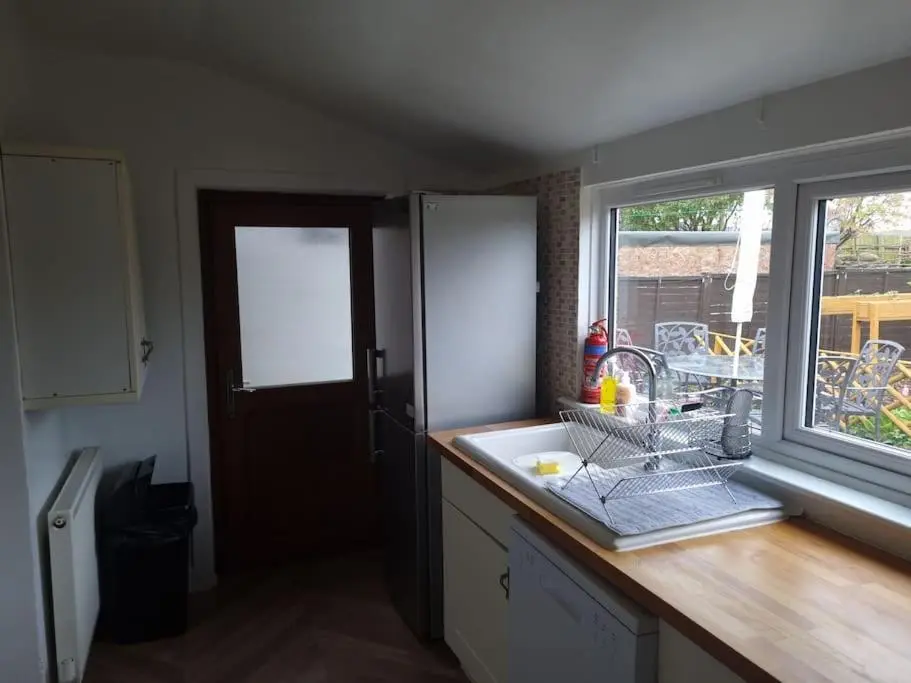 a kitchen counter with a sink and a window at Clava Cottage City Centre in Inverness
