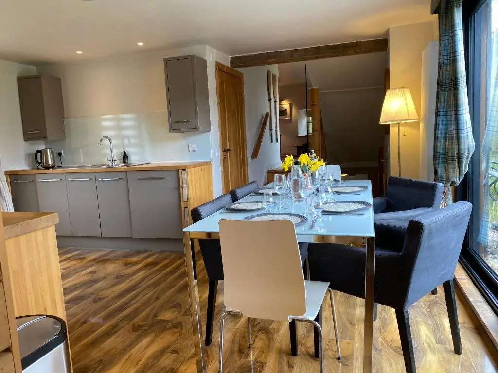 a kitchen and dining room with a table and chairs at Crofts Mill in Ballater