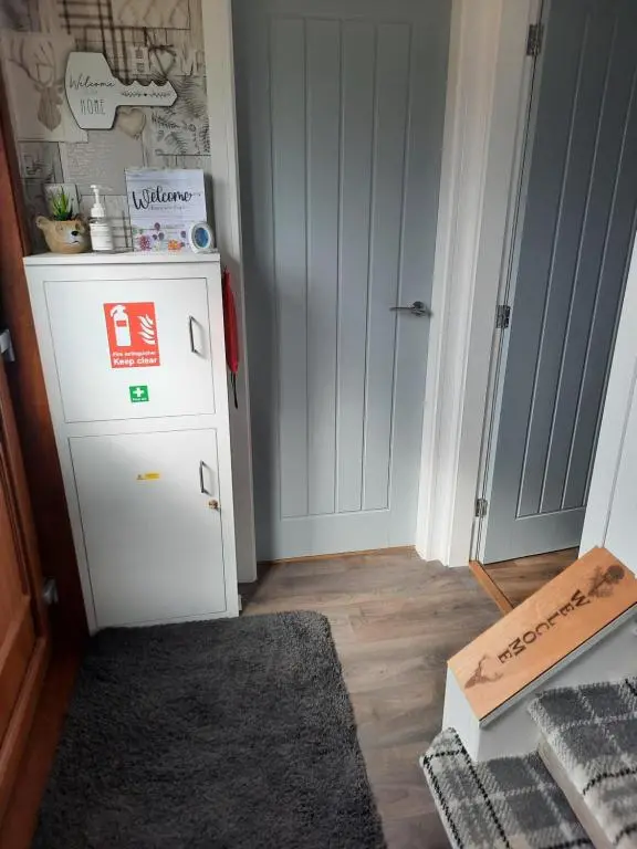 a small kitchen with a white refrigerator in a room at Ella's Hoose in Wick