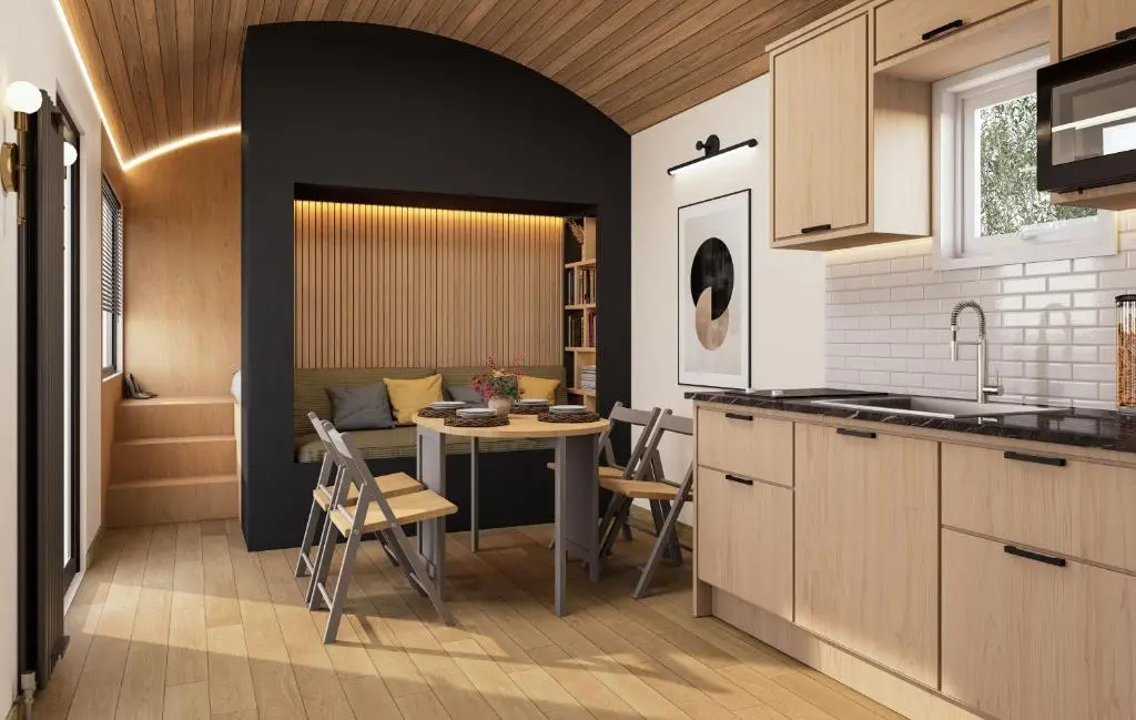 a kitchen with a table and a dining room at Highland Shepherd Huts in Nethy Bridge
