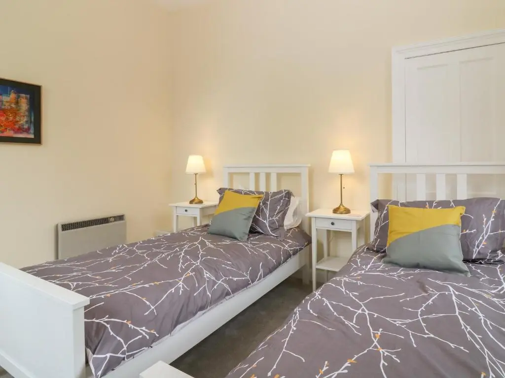 a bedroom with two beds and two lamps at East Wing - Castle Fraser in Inverurie
