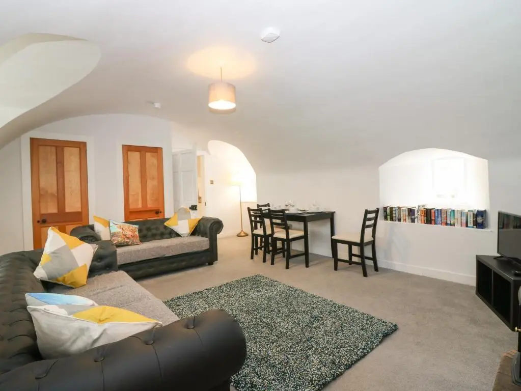 a living room with a couch and a table at East Wing - Castle Fraser in Inverurie